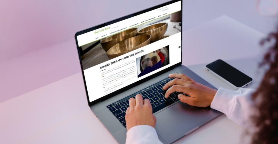 Woman looking at the Eastcott Barn website on a laptop