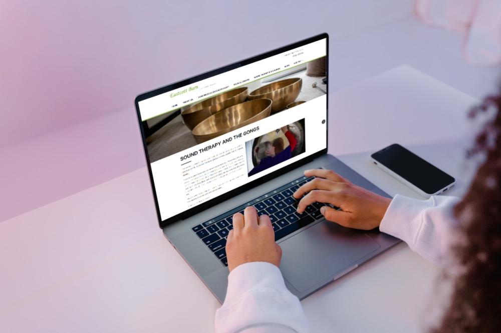 Woman looking at the Eastcott Barn website on a laptop