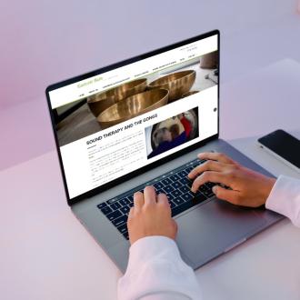 Woman looking at the Eastcott Barn website on a laptop